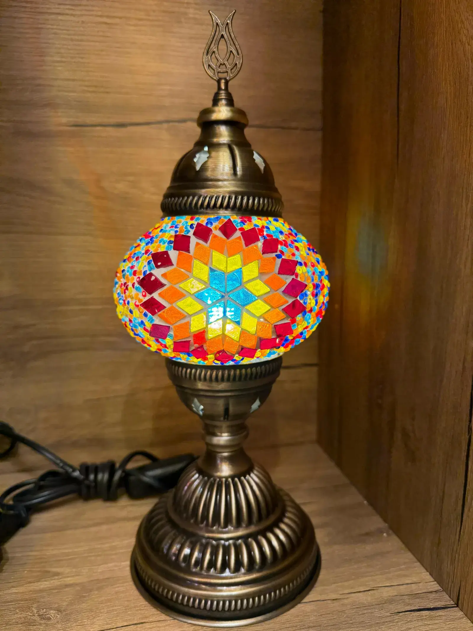 Geometric multicolour mosaic lamp glowing warm in our Balat workshop