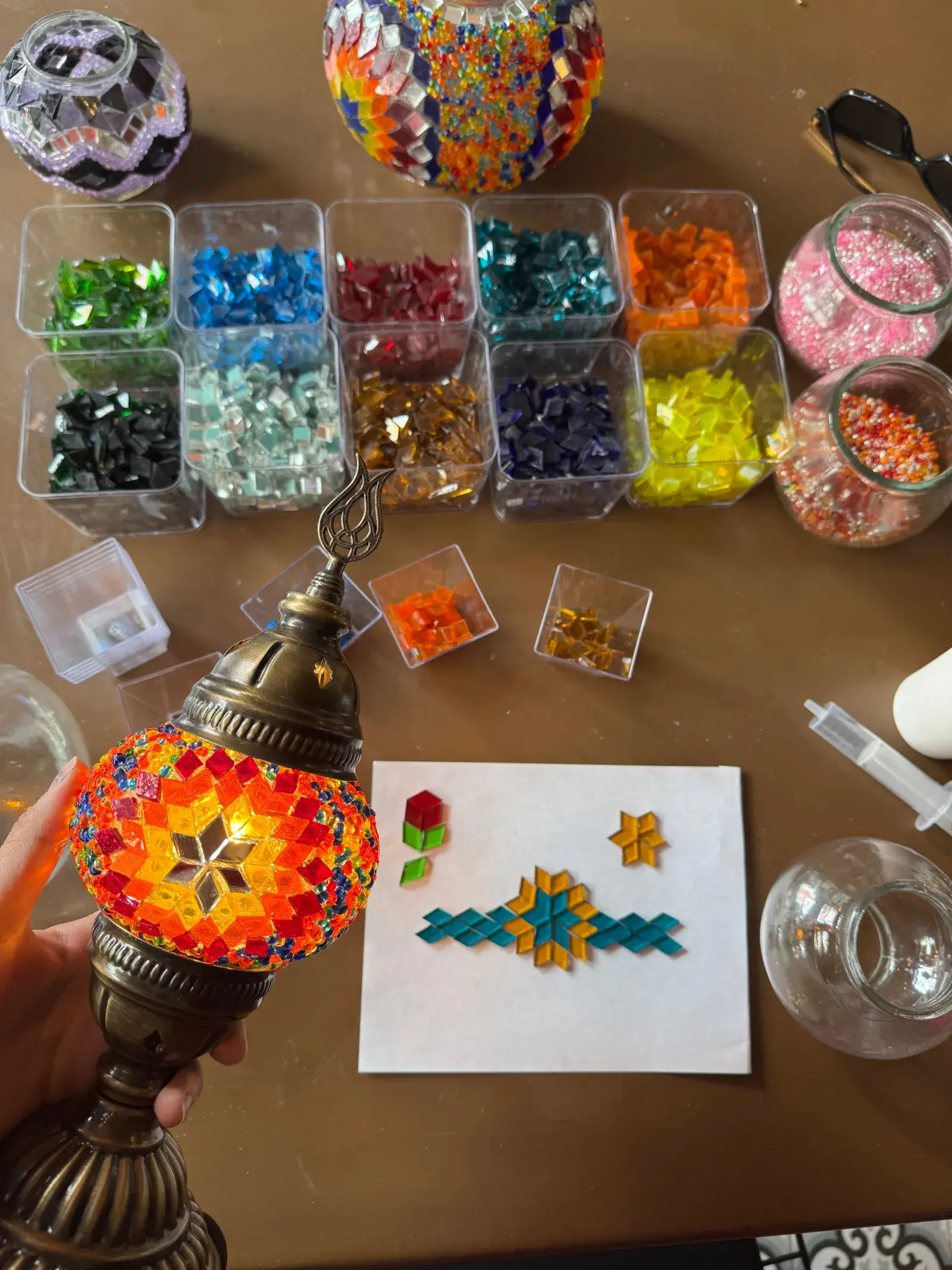 Overhead view of a mosaic lamp in progress on the workshop table in Istanbul