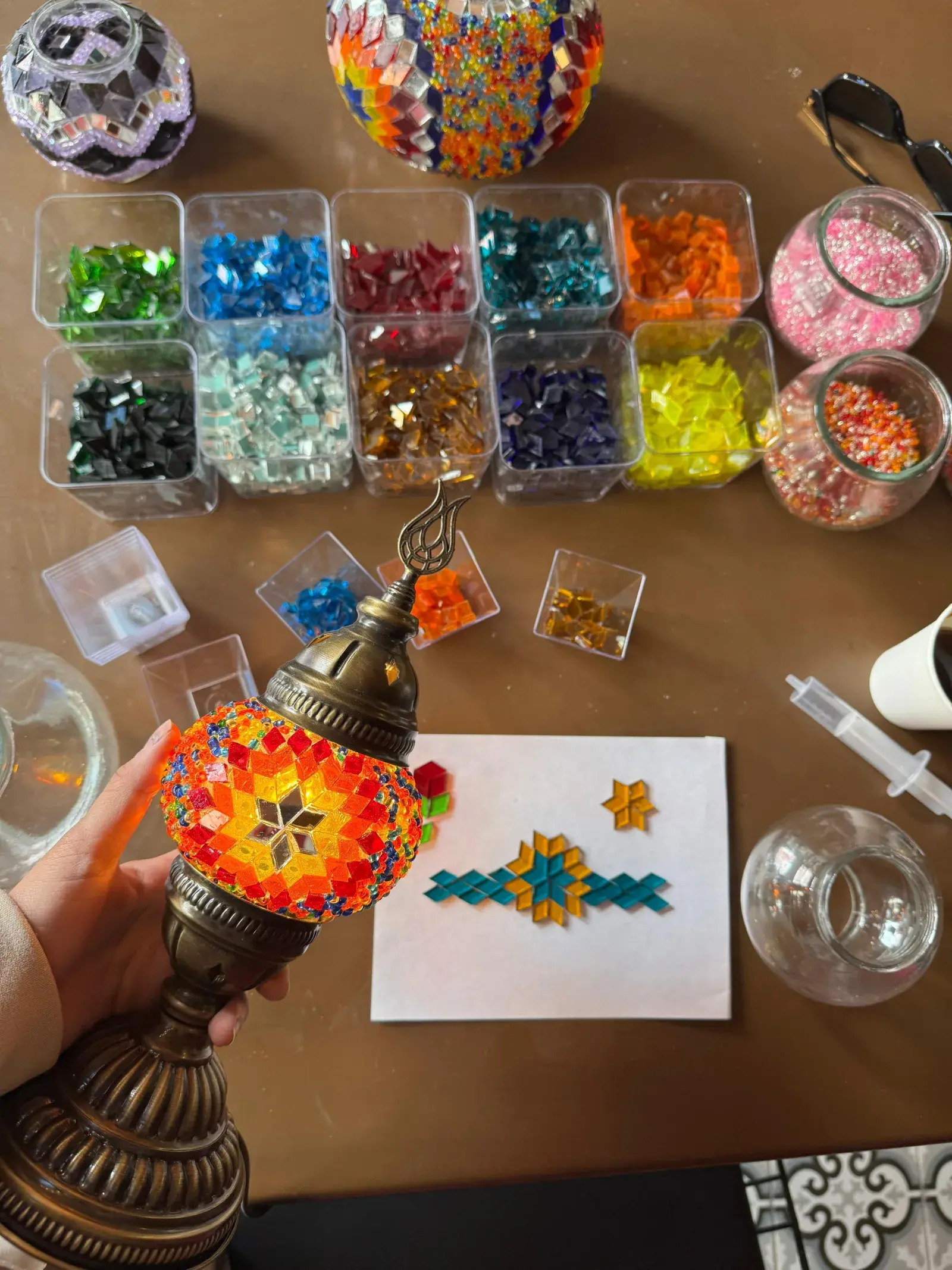 Guiding a guest through a mosaic lamp workshop in Istanbul