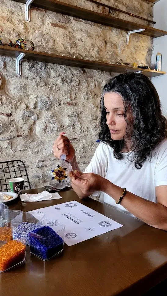 Selecting glass pieces during a mosaic lamp workshop in Balat, Istanbul