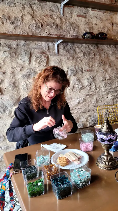 A guest working on her lamp at the worktable